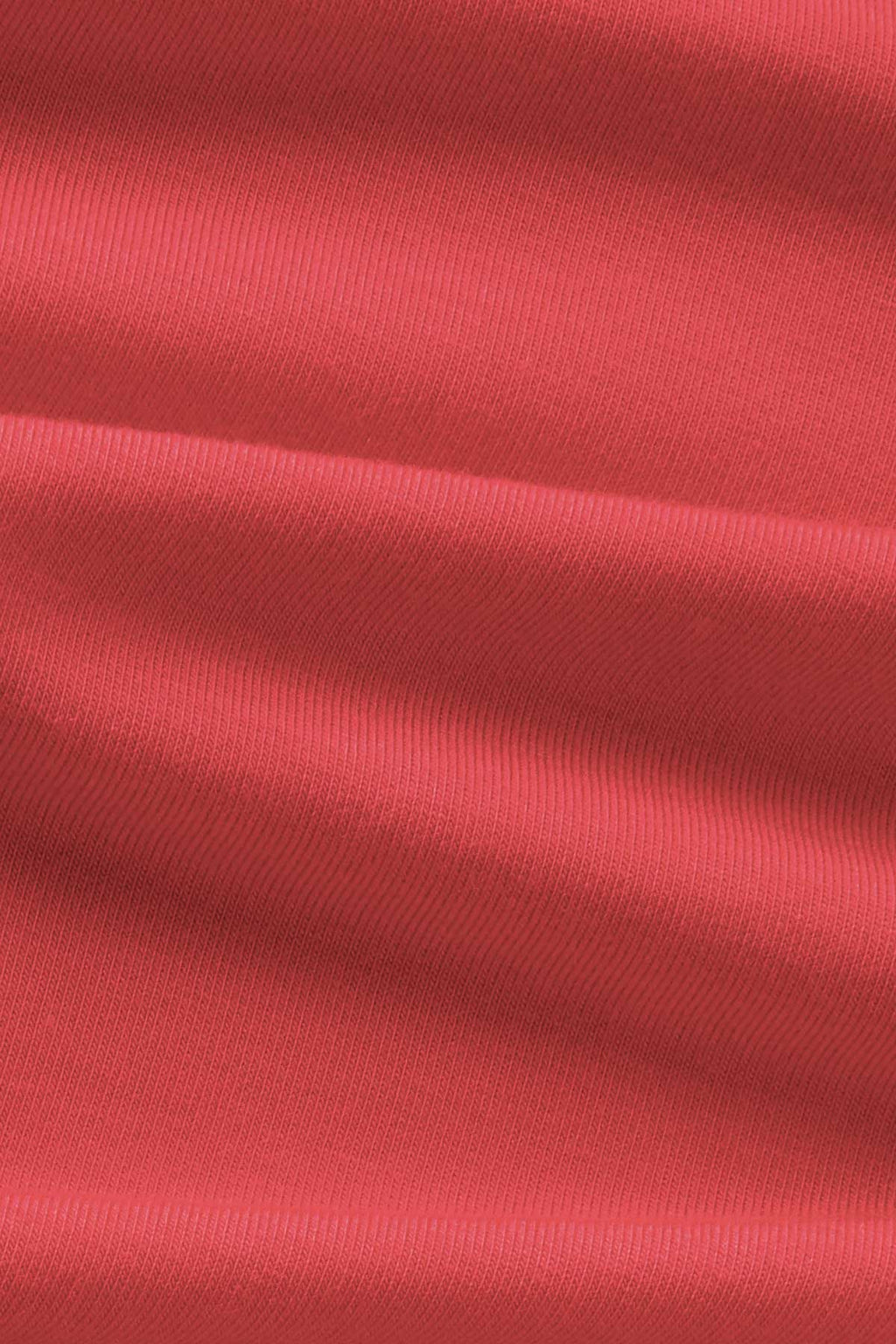 Cayenne-colored ribbed fabric with diagonal texture and natural folds.