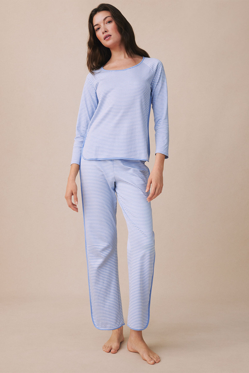 Woman wearing blue and white striped long-sleeve top and matching pants.