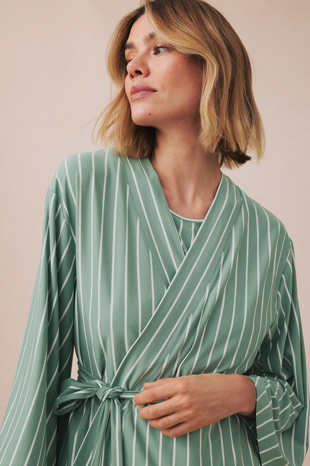 Boxwood green kimono with vertical white stripes, wrap front closure, and tie waist detail.