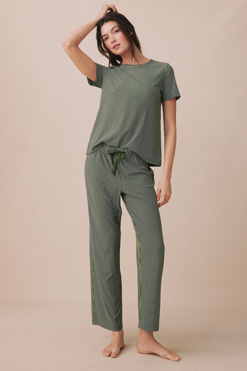 Woman wearing rosemary green vertical striped short-sleeve top and matching drawstring pants.