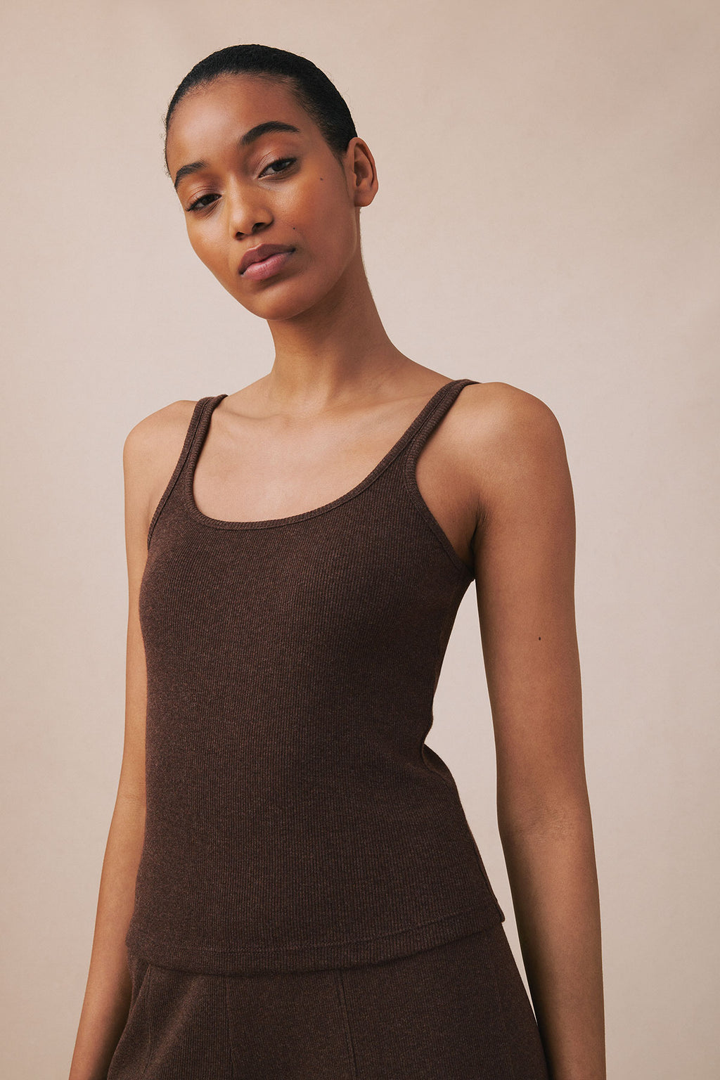 Brown ribbed tank top and matching pants in cocoa heather color displayed on model.