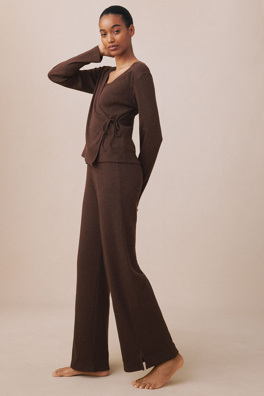 Woman wearing cocoa heather wrap top with tie waist and matching wide-leg ribbed pants, full-length view.