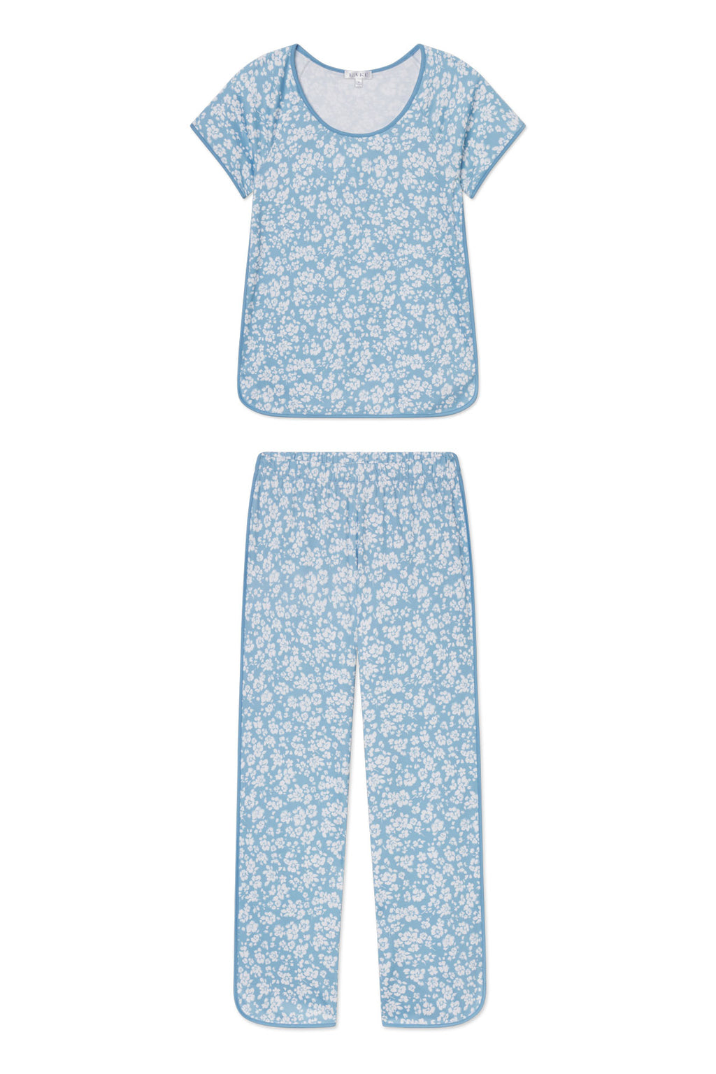 The Pima Short-Long Set in Serene Blue Anemones features a soft Pima cotton short-sleeve top and breathable pants with a white floral print and light blue trim, shown laid flat against a white background.