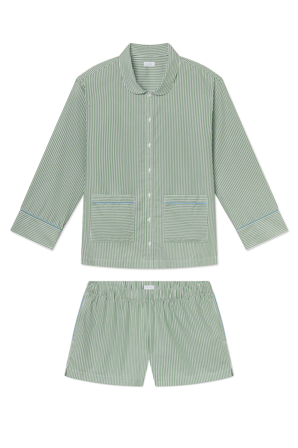 The Poplin Piped Long-Short Set in Palm Riviera Stripe features green and white striped cotton, a long-sleeve button-up top with two front pockets and piping, and matching elastic-waist shorts, shown laid flat on a white background.