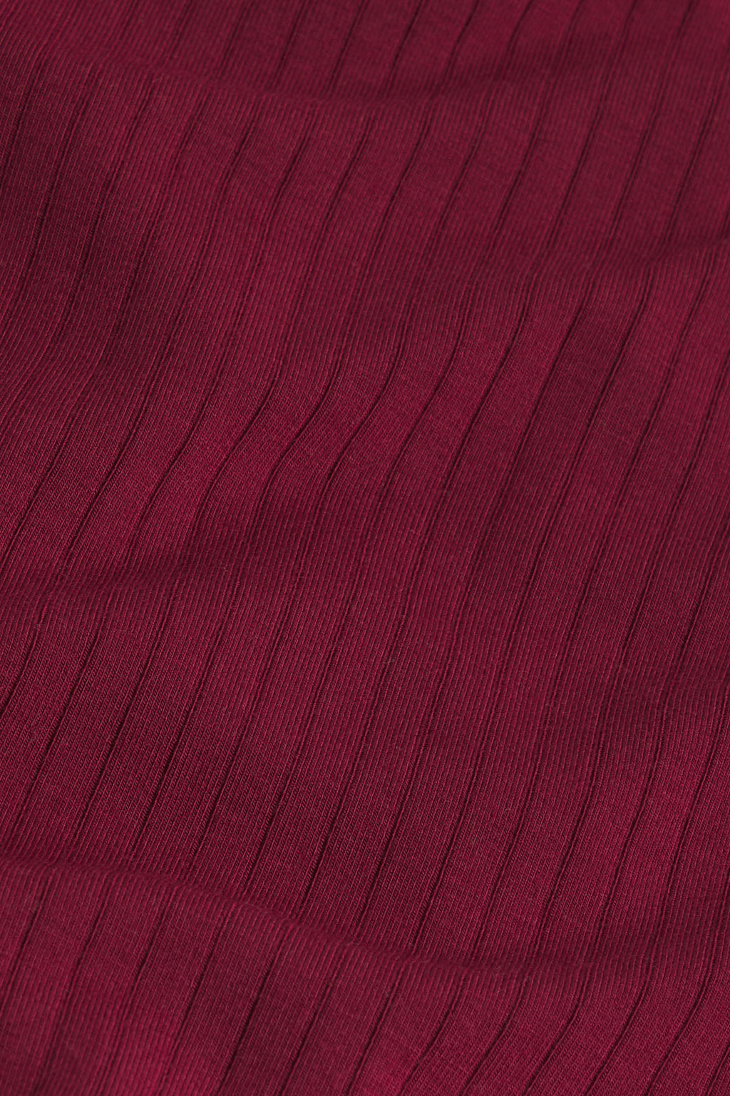 Burgundy ribbed fabric with vertical texture detail on nightgown.