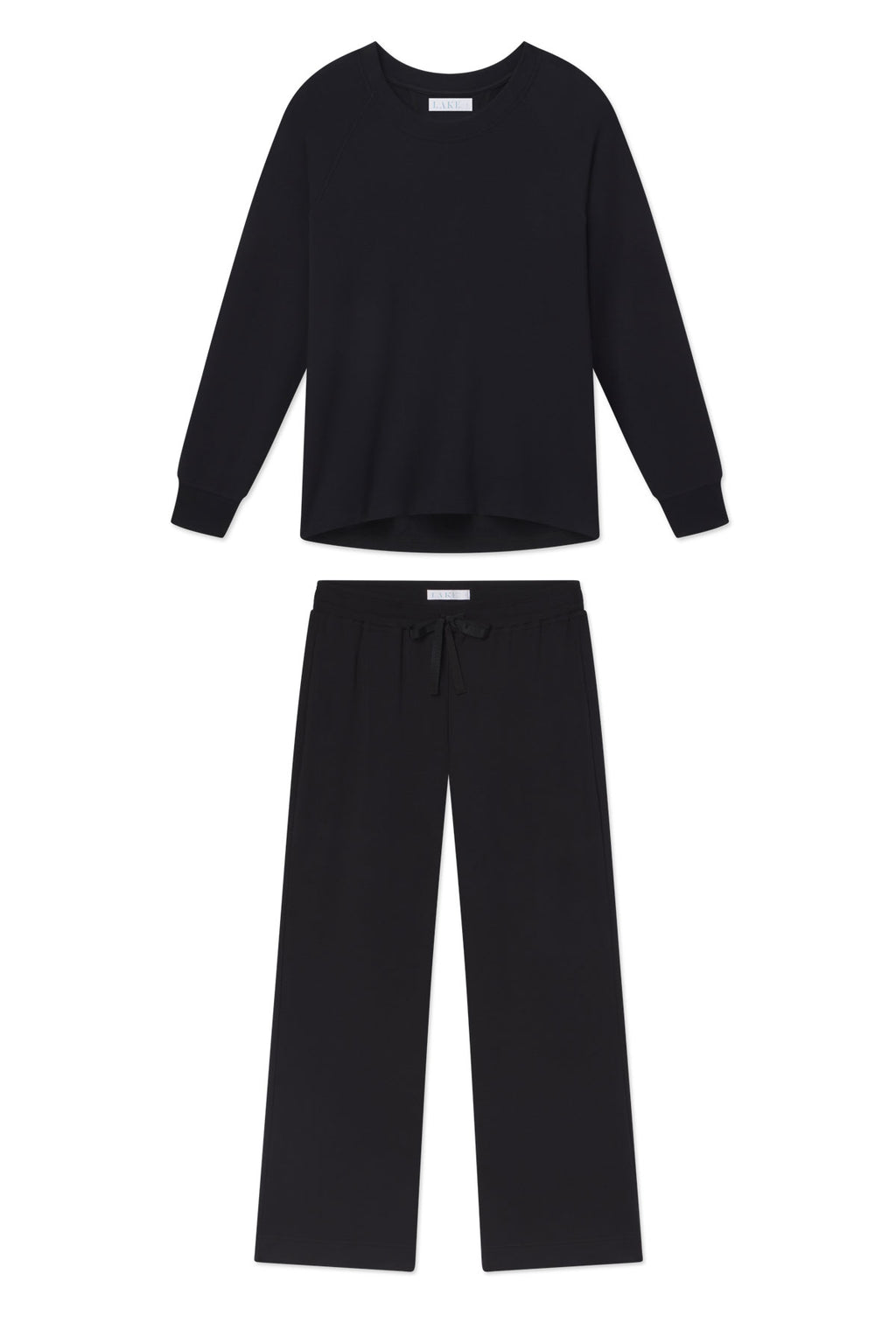 The Relax Pants Set in Black features a soft modal long-sleeve crewneck top and wide-leg drawstring pants, shown laid flat on a white background.
