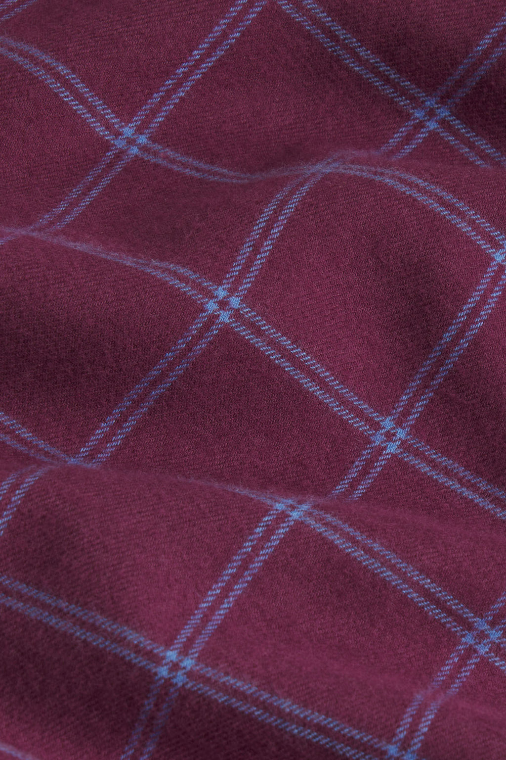 Burgundy flannel fabric with blue windowpane plaid pattern.