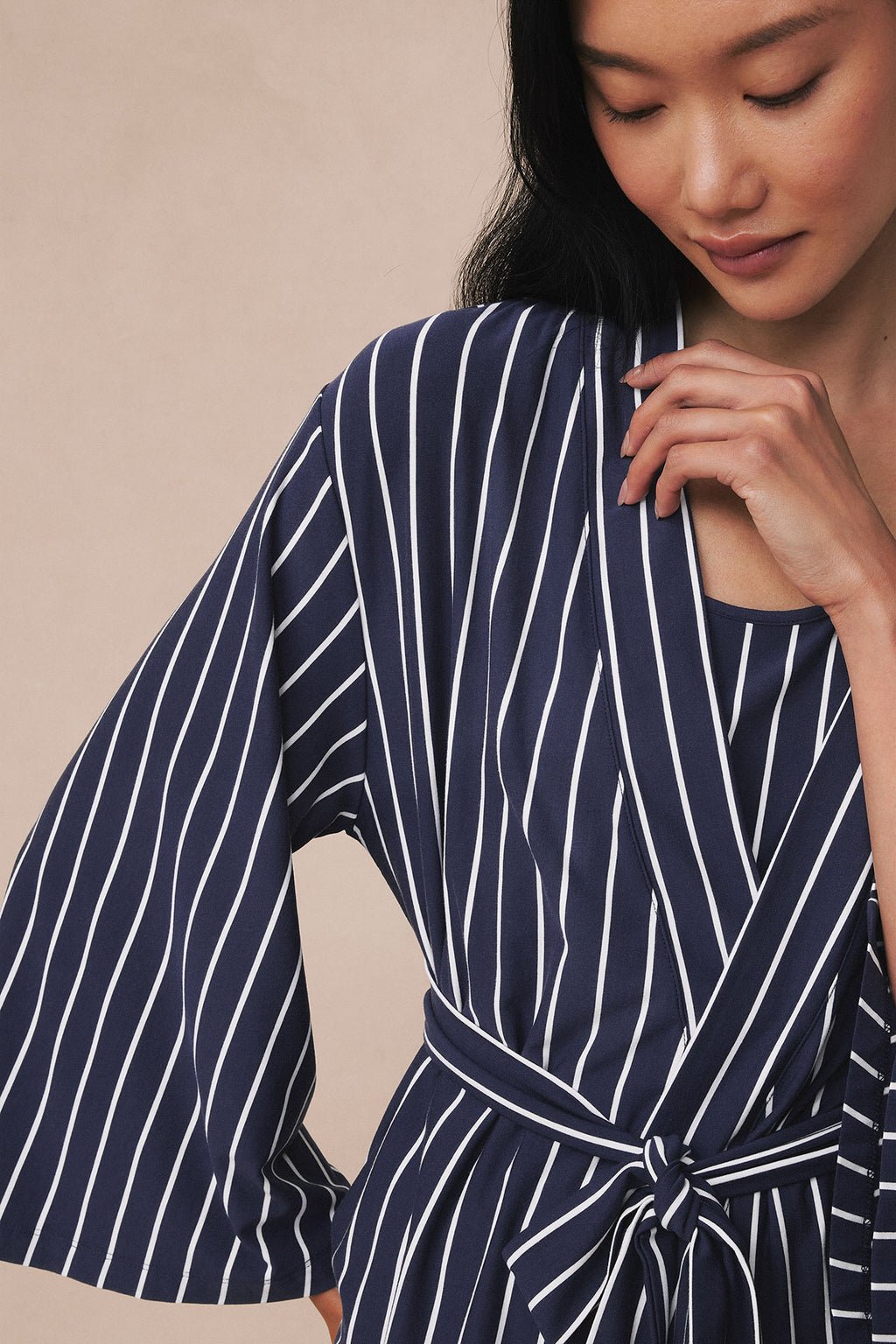 Navy and white vertical striped kimono with tie waist and wide sleeves.