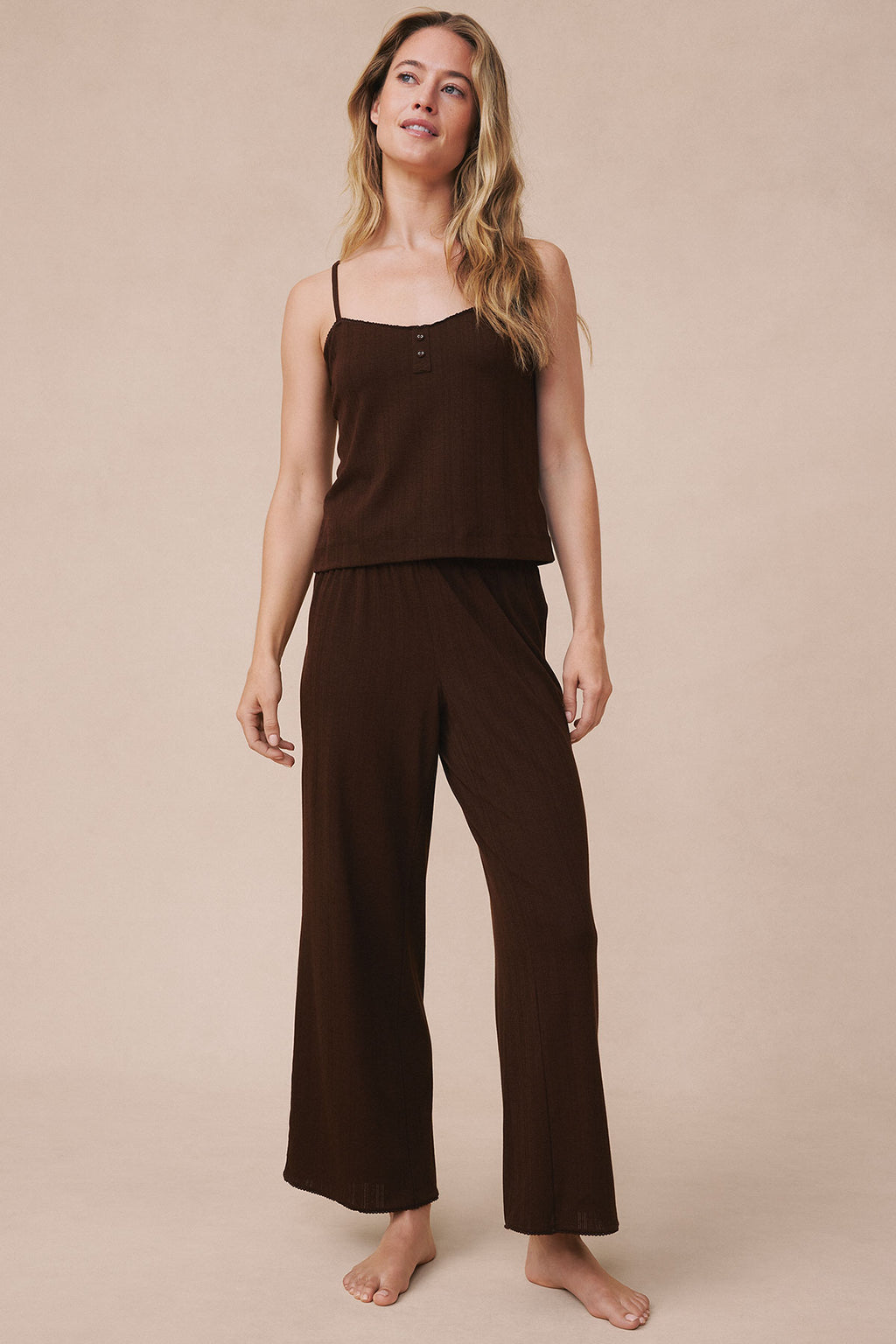 Woman wearing cocoa brown pointelle camisole top and matching wide-leg pants against neutral background.