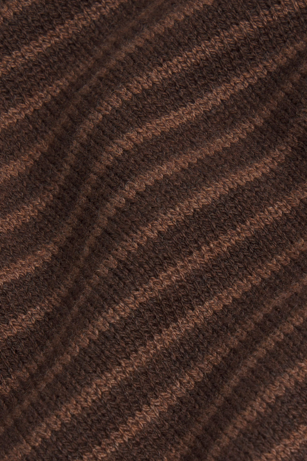Brown and tan striped knit fabric with diagonal meander pattern texture.