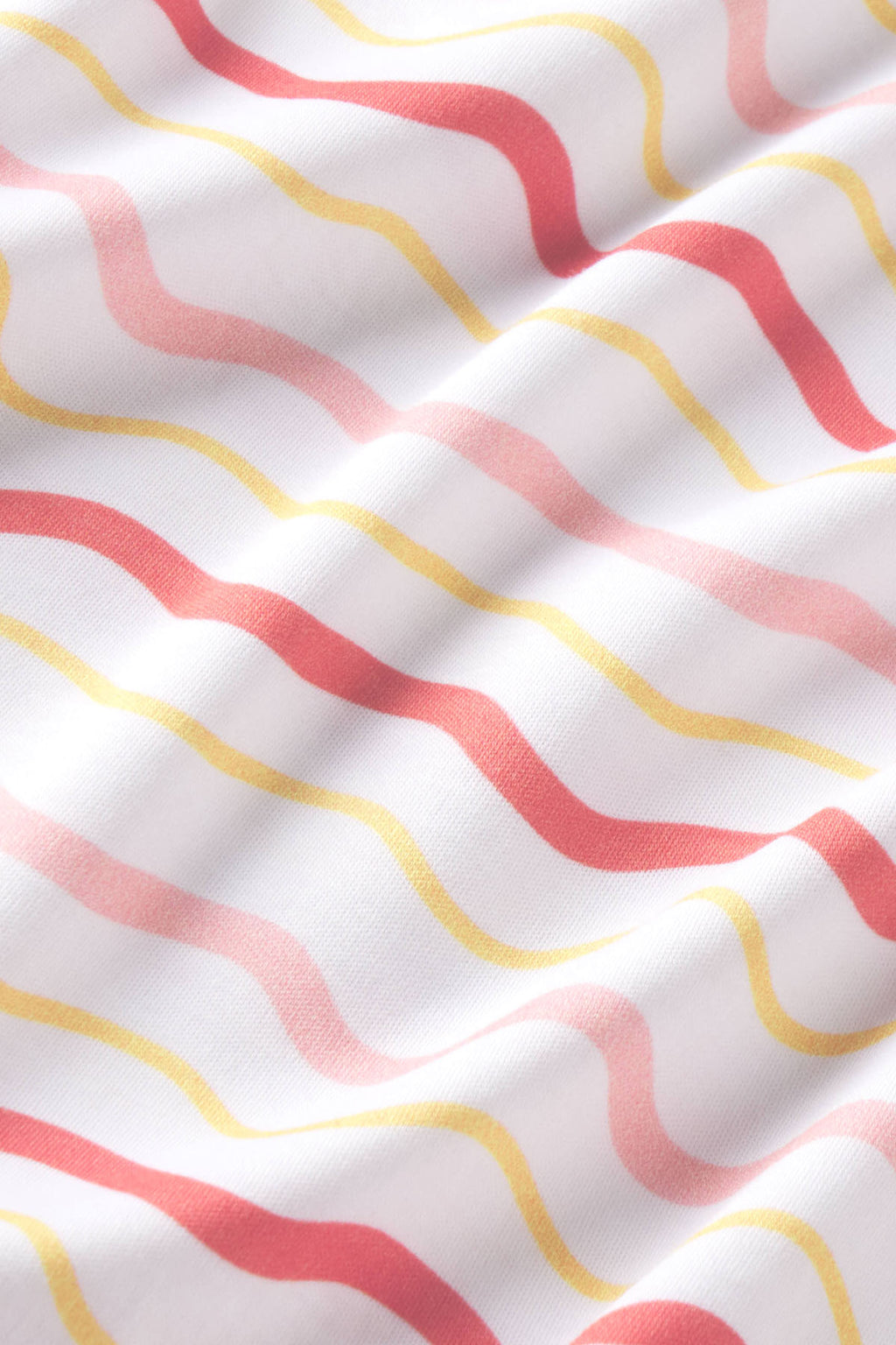 White fabric with coral, pink, and yellow wavy stripes in a repeating pattern.