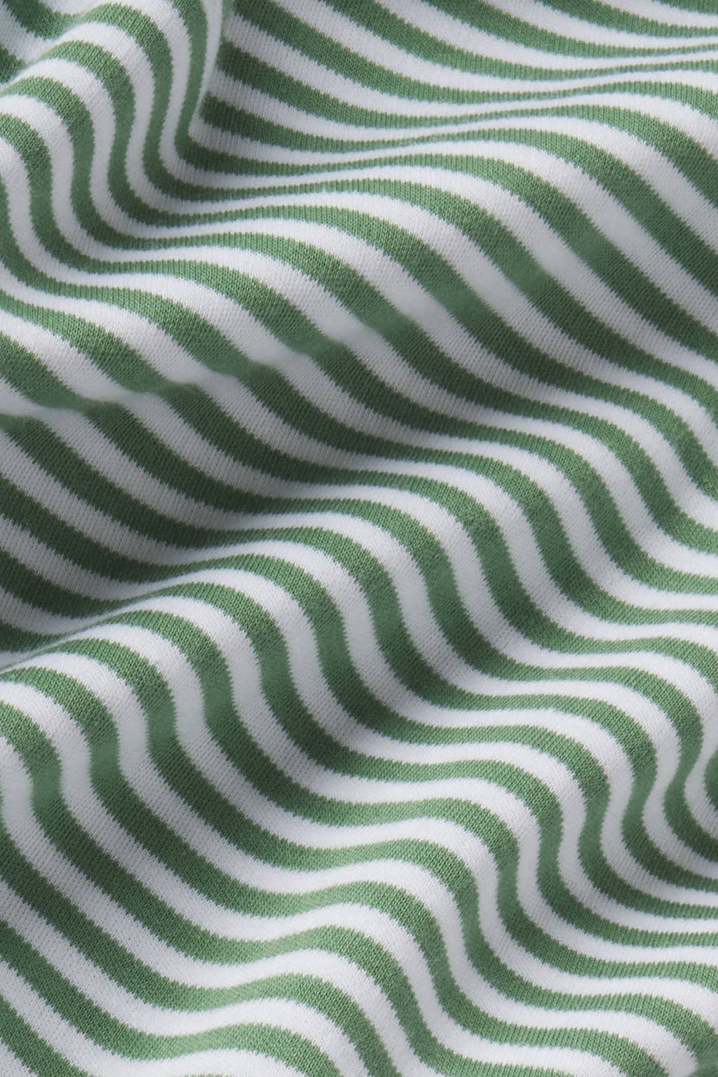 Green and white wavy stripe pattern on ribbed knit fabric.