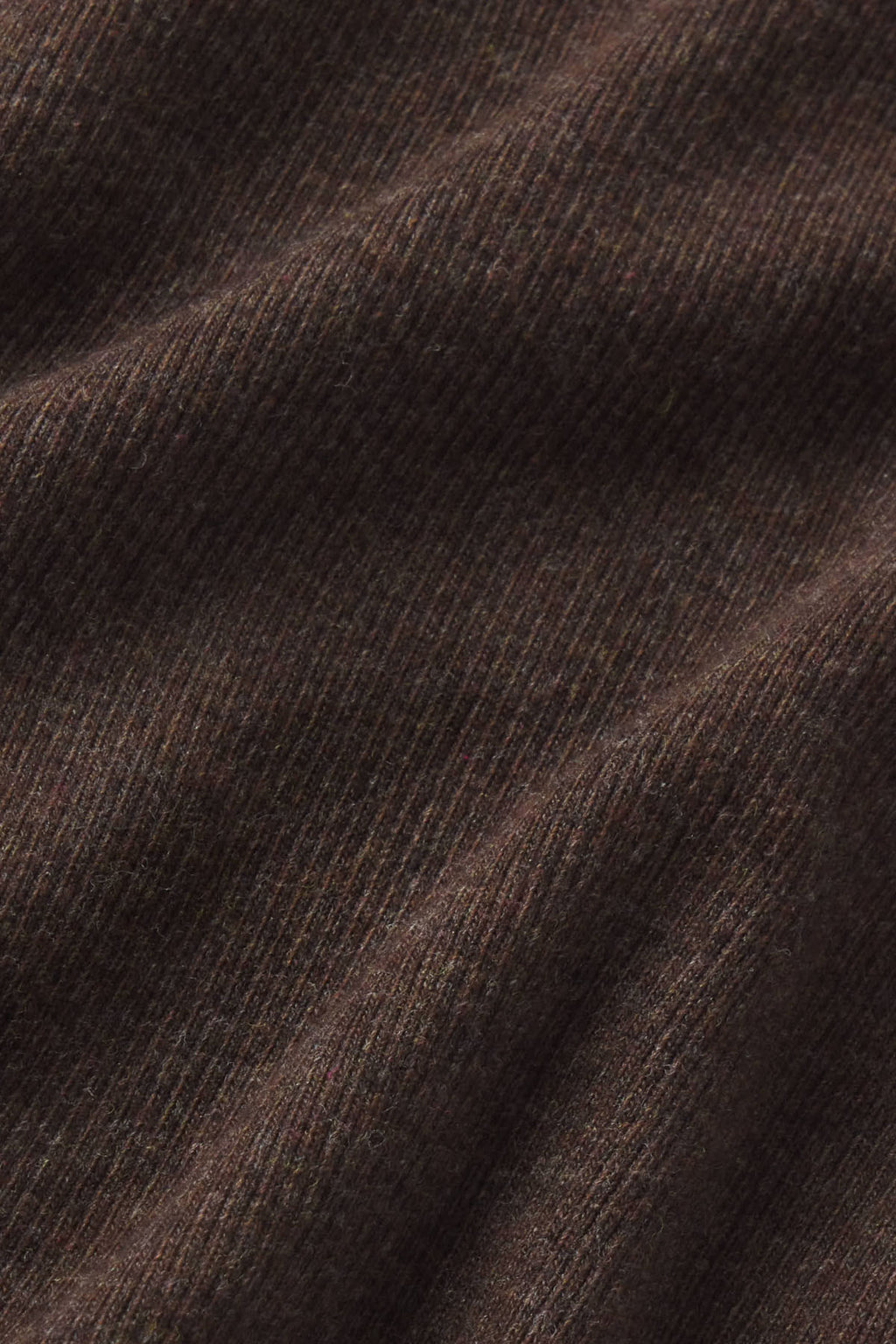 Close-up of cocoa heather ribbed fabric texture with diagonal folds.