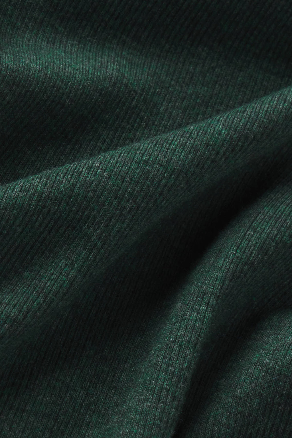 Close-up of trekking green heather ribbed fabric with visible texture and draping.