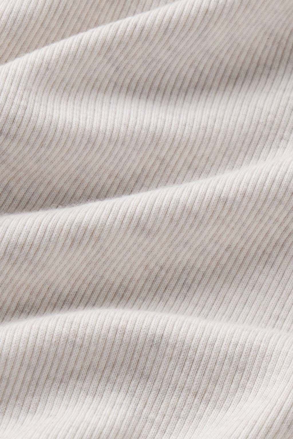 Stone heather ribbed fabric with vertical texture and subtle folds.