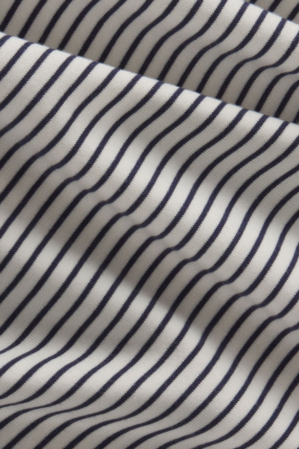 Ribbed fabric with vertical navy and white stripes in alternating pattern.